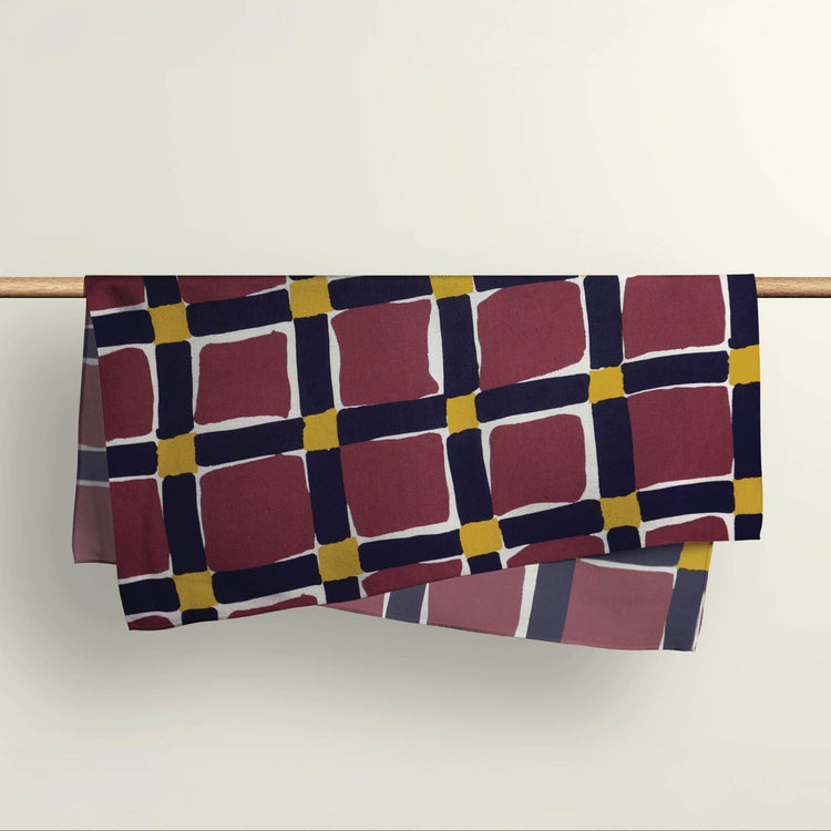 The Unchained pattern fabric wrap draped over a wooden rod to show the premium deadstock material texture.