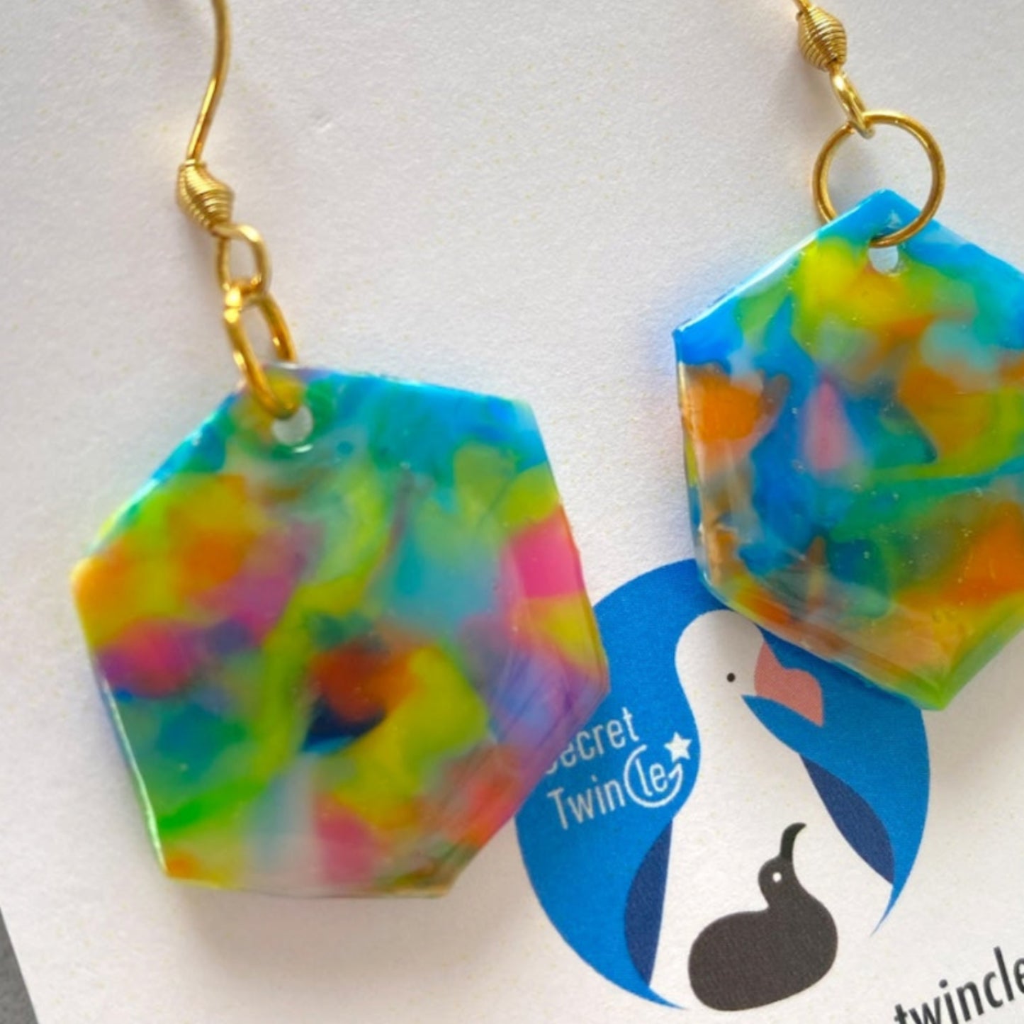 Detailed close-up highlighting the unique marbled surface finish and artisan blue color blend of the recycled plastic hexagon earrings.