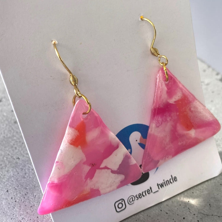 Detailed close-up highlighting the unique artisan marbled texture, smooth finish, and pink-white color variations of the recycled plastic earrings.