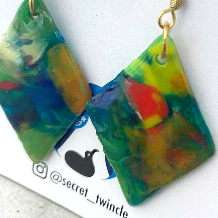 Detailed close-up highlighting the artisan marbled texture, smooth finish, and distinctive color swirls on the green blue eco-friendly dangle earrings.
