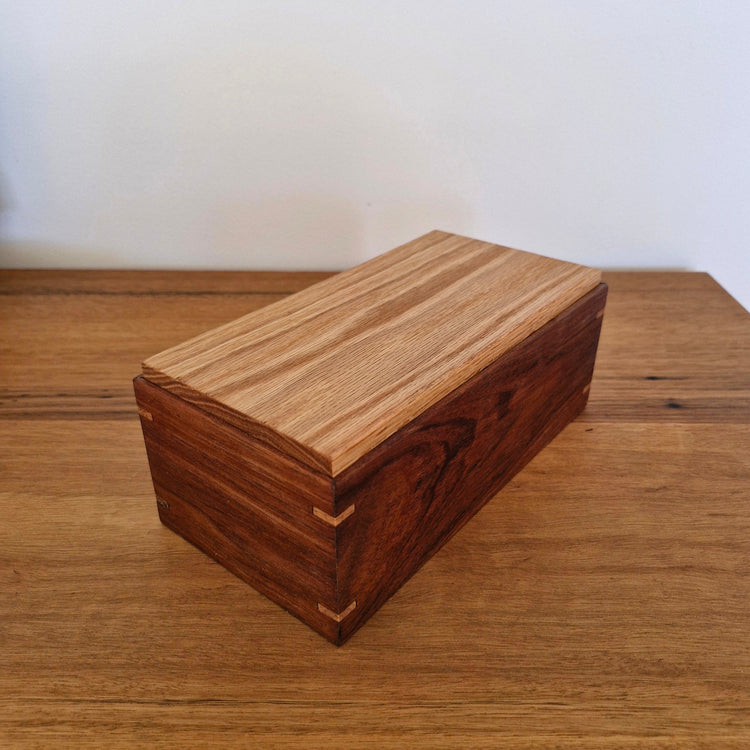 Top-down angle of a unique handcrafted wooden storage box, showcasing sustainable upcycled timber grain.