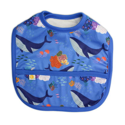 Lightweight waterproof baby bib in Whales with an integrated crumb catch-all front pocket closed.