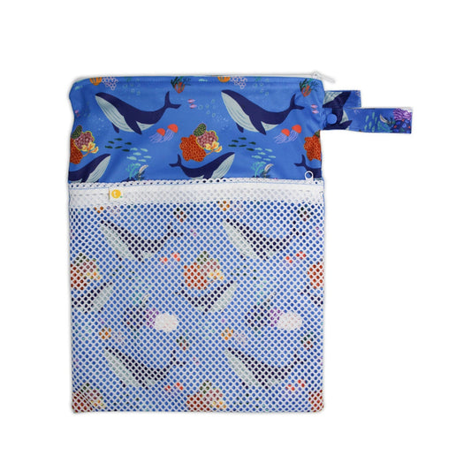 Waterproof baby travel wet bag in Whales print, featuring a secure zipper and snap pram loop.