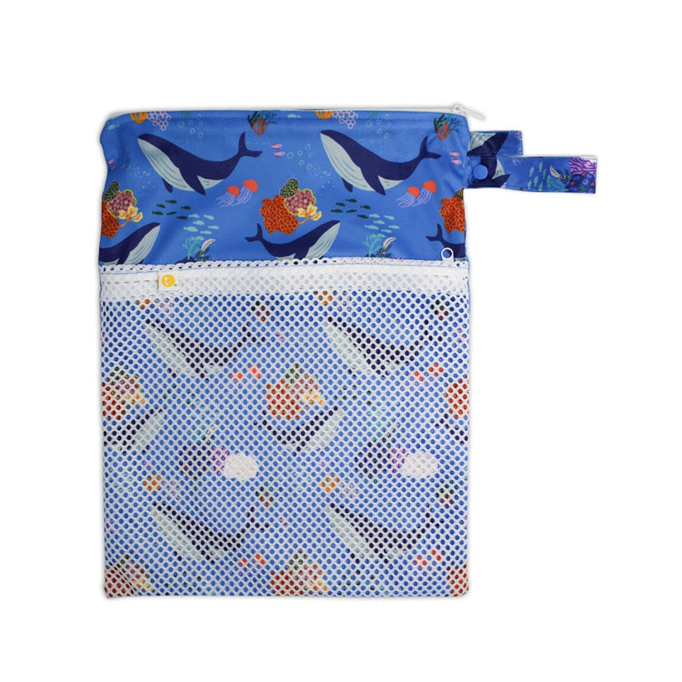Waterproof baby travel wet bag in Whales print, featuring a secure zipper and snap pram loop.