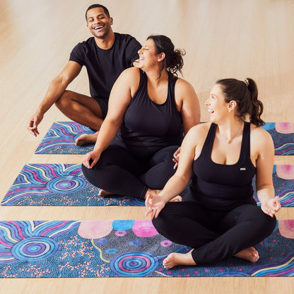 Yoga Mat | Wild Mingo | Oorunye Recycled Rubber & Microsuede Non-Slip unrolled on a studio floor with three people