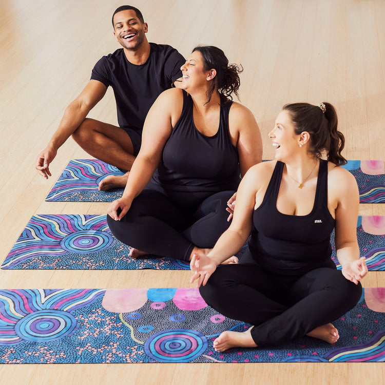 Yoga Mat | Wild Mingo | Oorunye Recycled Rubber & Microsuede Non-Slip unrolled on a studio floor with three people