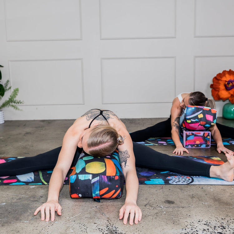 Wild Mingo printed eco yoga bolster used for back alignment and support during an at home yin yoga or meditation routine.