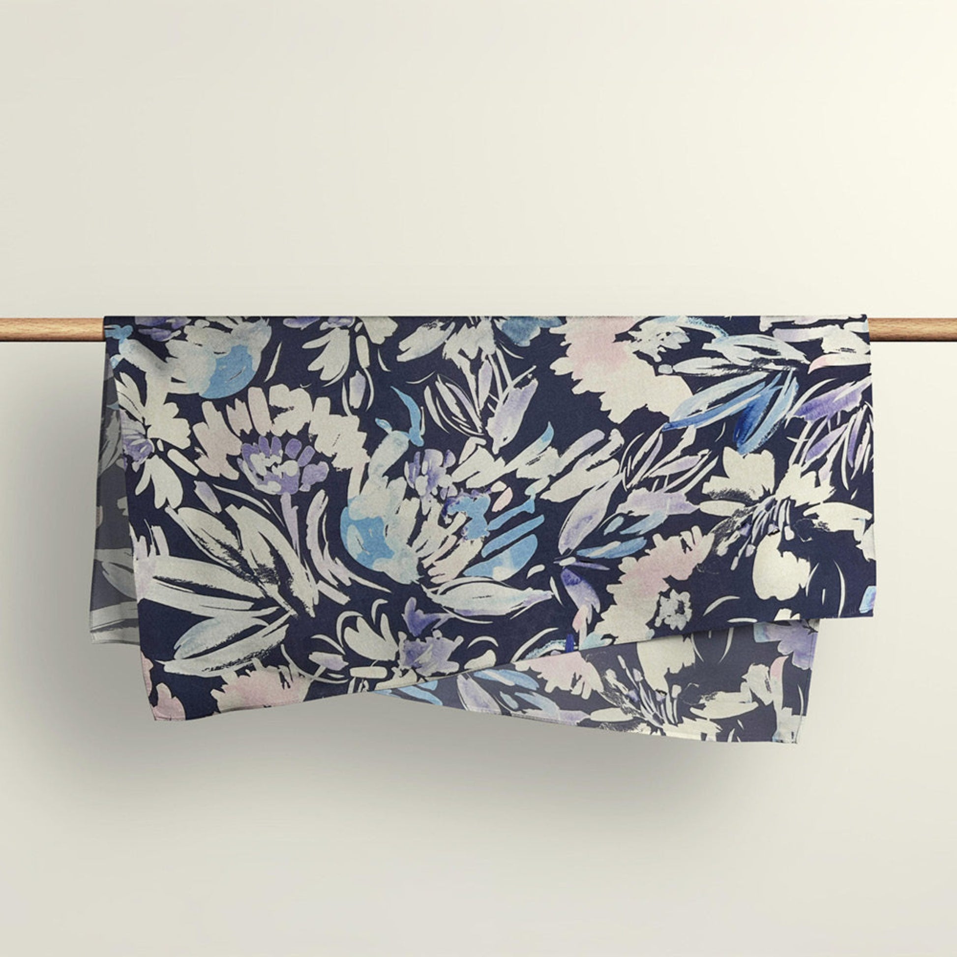 The Wildflowers floral fabric wrap draped over a wooden rod to show the premium deadstock material texture.