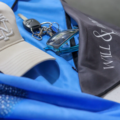 Close up view of the open integrated zip pocket feature on a Will and Wind quick dry microfibre gym towel for securing keys and phone.