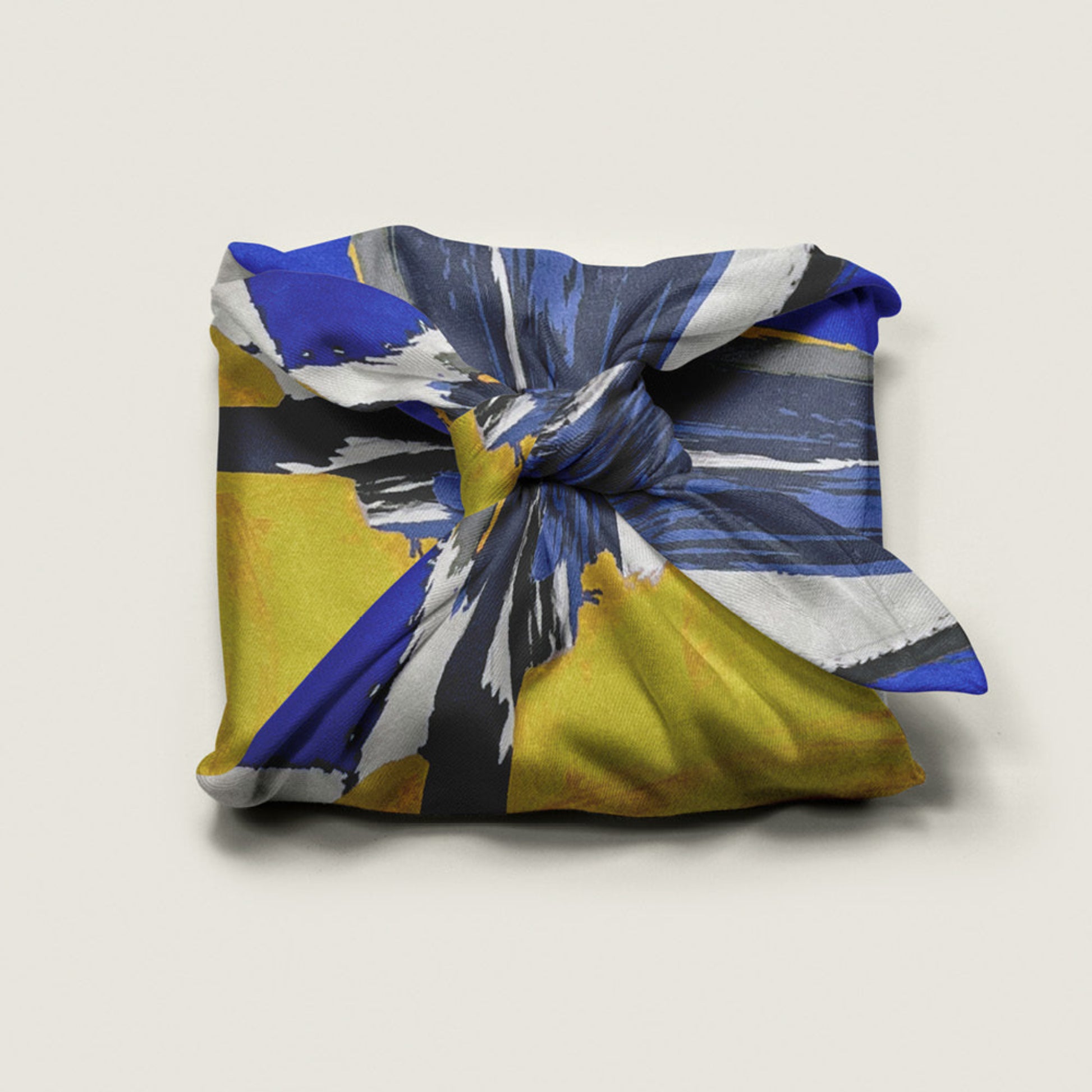 Wrap Revolution Painterly fabric gift wrap tied around a gift box. Sustainable furoshiki wrap in Australia.