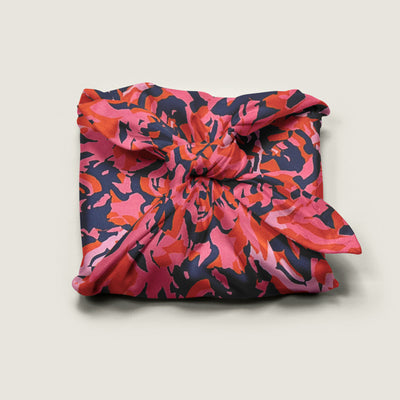 Wrap Revolution Pink Mess fabric gift wrap tied around a gift box. Sustainable furoshiki wrap in Australia.