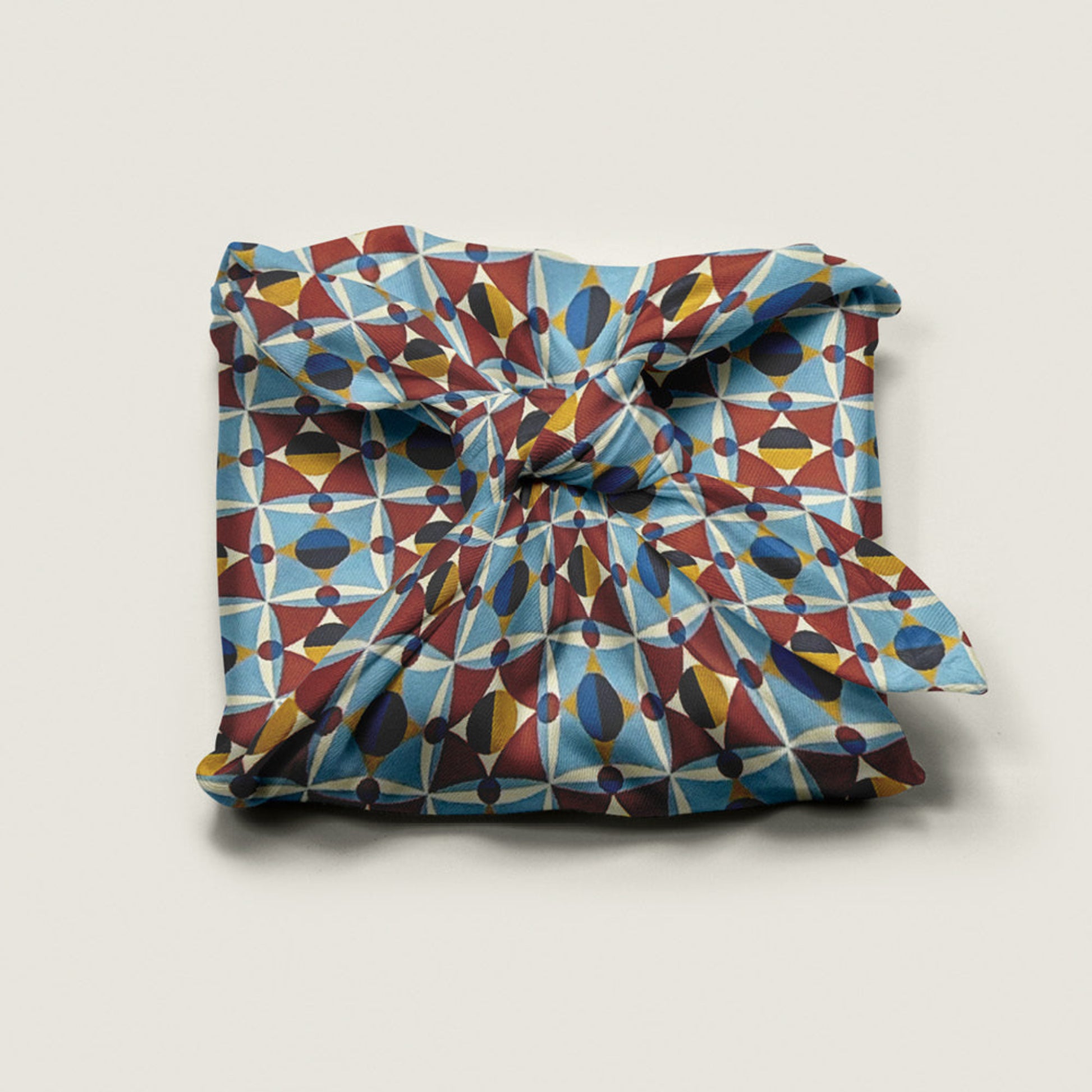 Wrap Revolution Shapeshifter fabric gift wrap tied around a gift box. Sustainable furoshiki wrap in Australia.