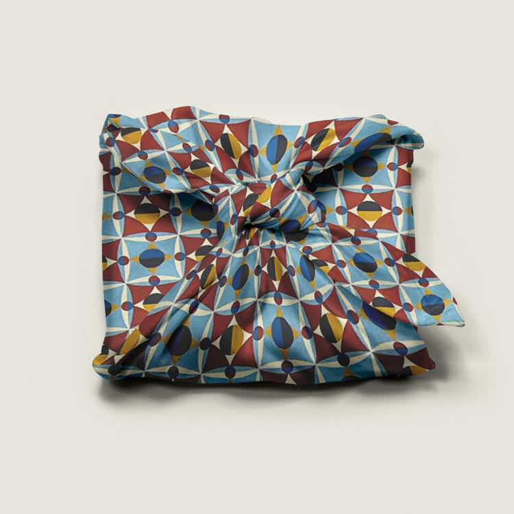 Wrap Revolution Shapeshifter fabric gift wrap tied around a gift box. Sustainable furoshiki wrap in Australia.