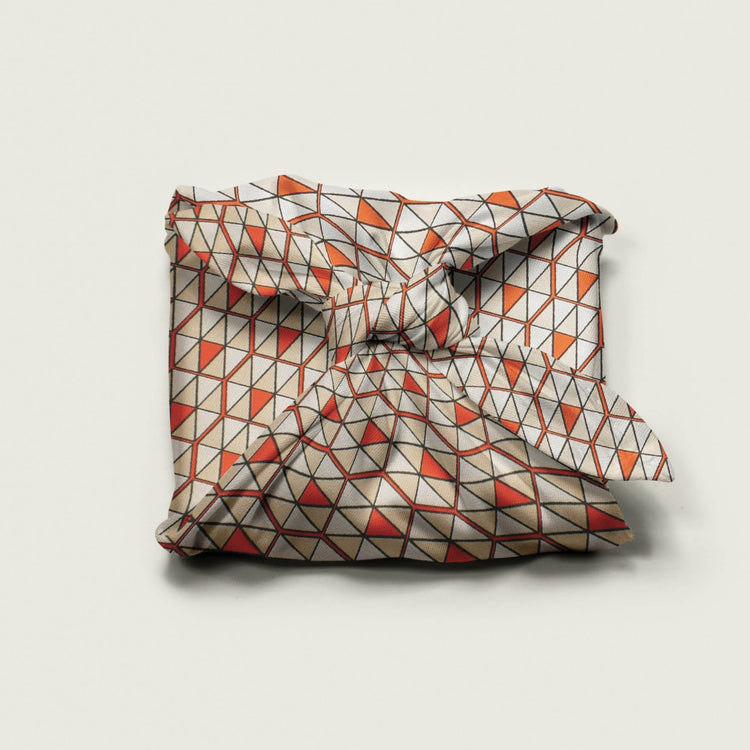Wrap Revolution Triangulation fabric gift wrap tied around a gift box. Sustainable furoshiki wrap in Australia.