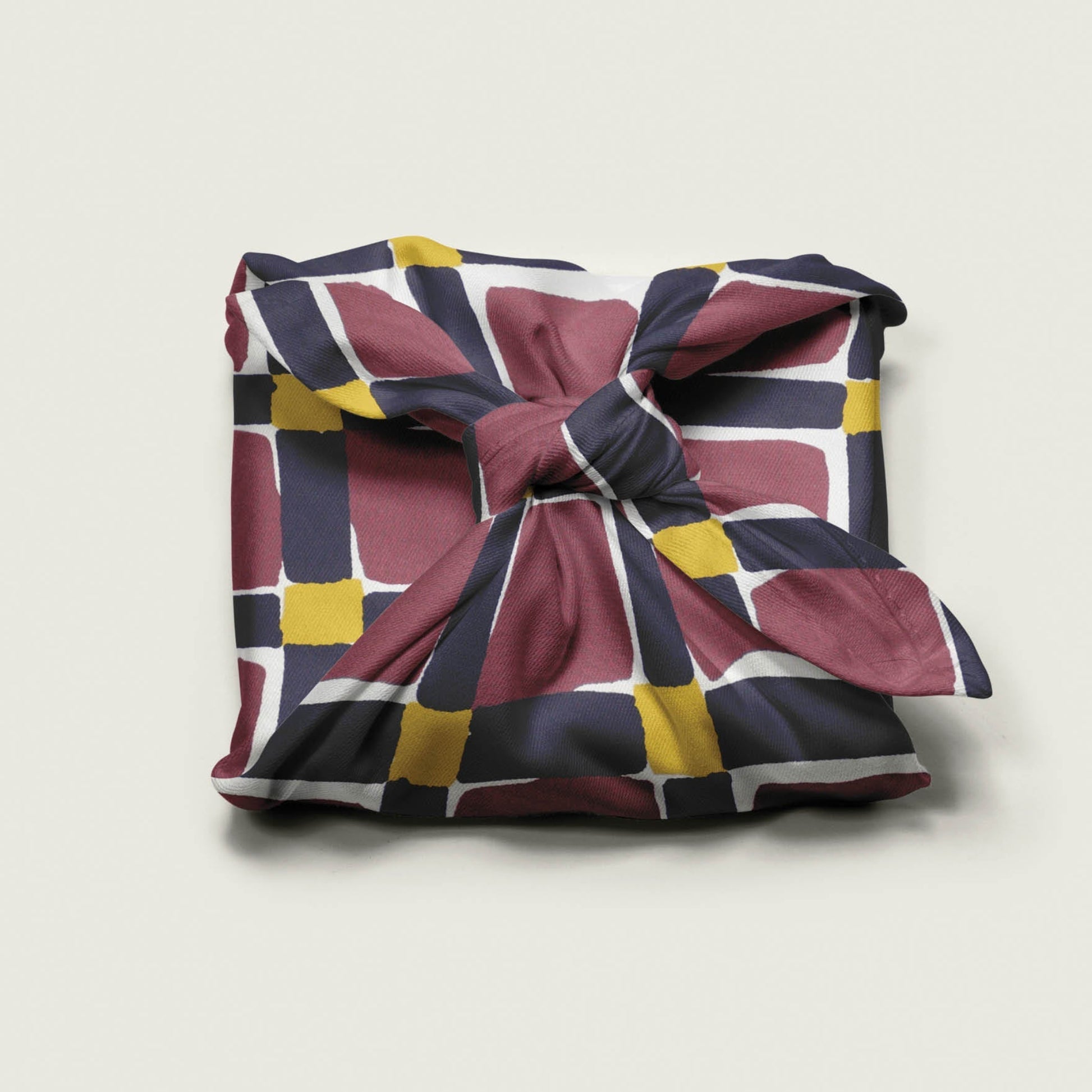 Wrap Revolution Unchained fabric gift wrap tied around a gift box. Sustainable furoshiki wrap in Australia.