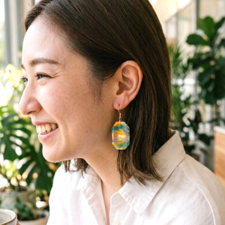 On-model style shot showing the drop length, geometric scale, and visual appeal of the upcycled yellow and green octagon dangle earrings.