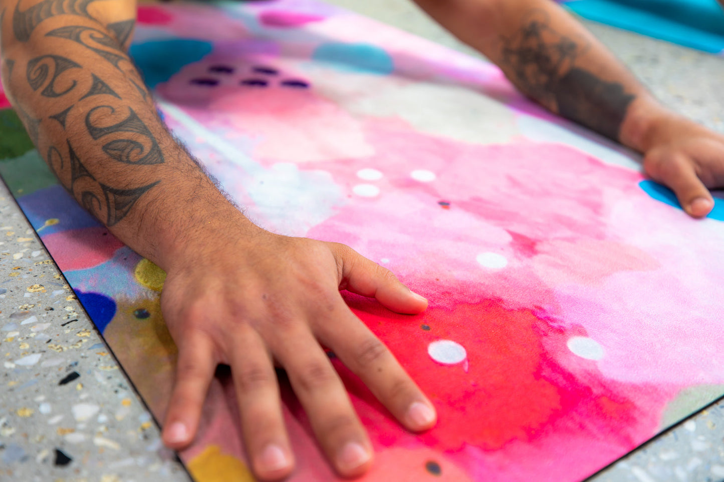 Man's hands on Wild Mingo Yoga Mat Joy in a yoga studio