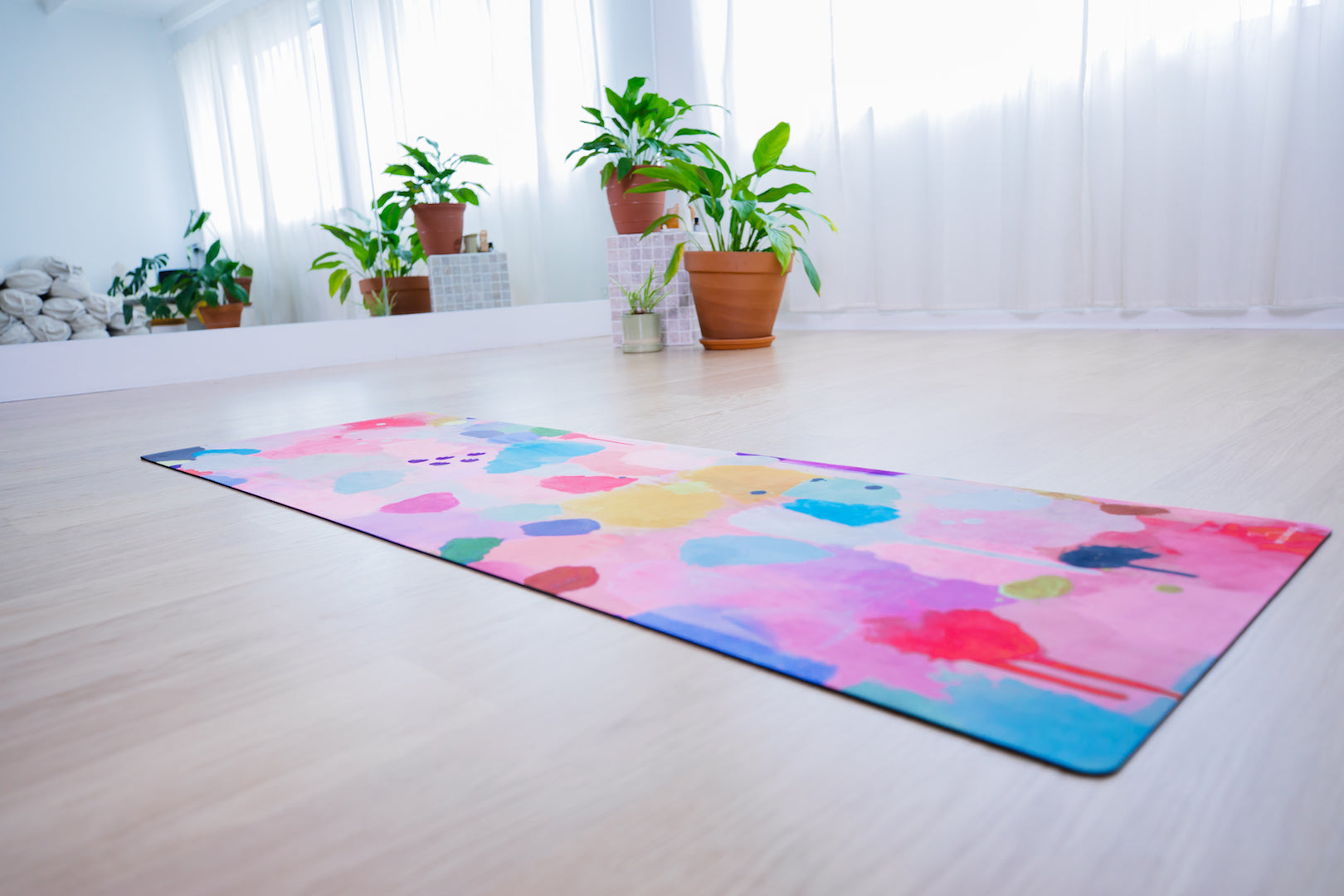 Yoga Mat | Wild Mingo| Joy on the floor of a yoga studio with pot plants