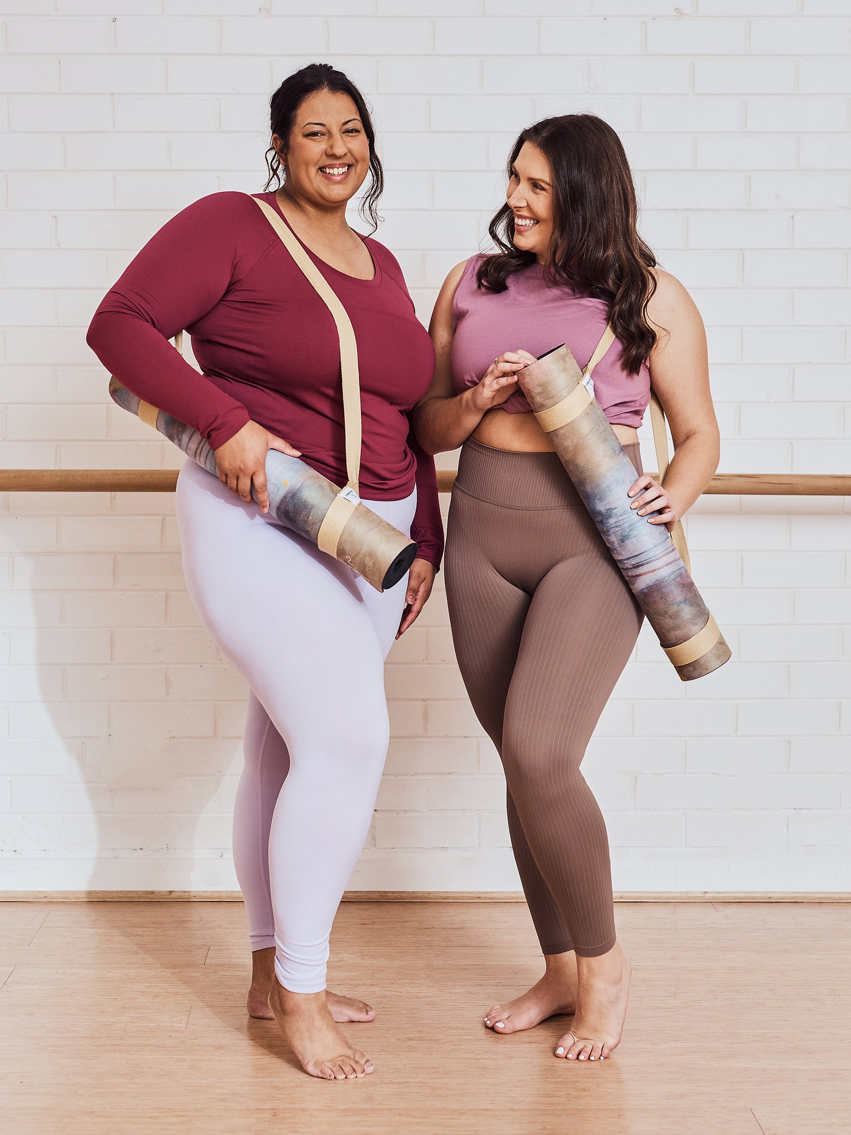Yoga Mat | Wild Mingo | Nude Recycled Rubber & Microsuede Non-Slip rolled with strap held by two women