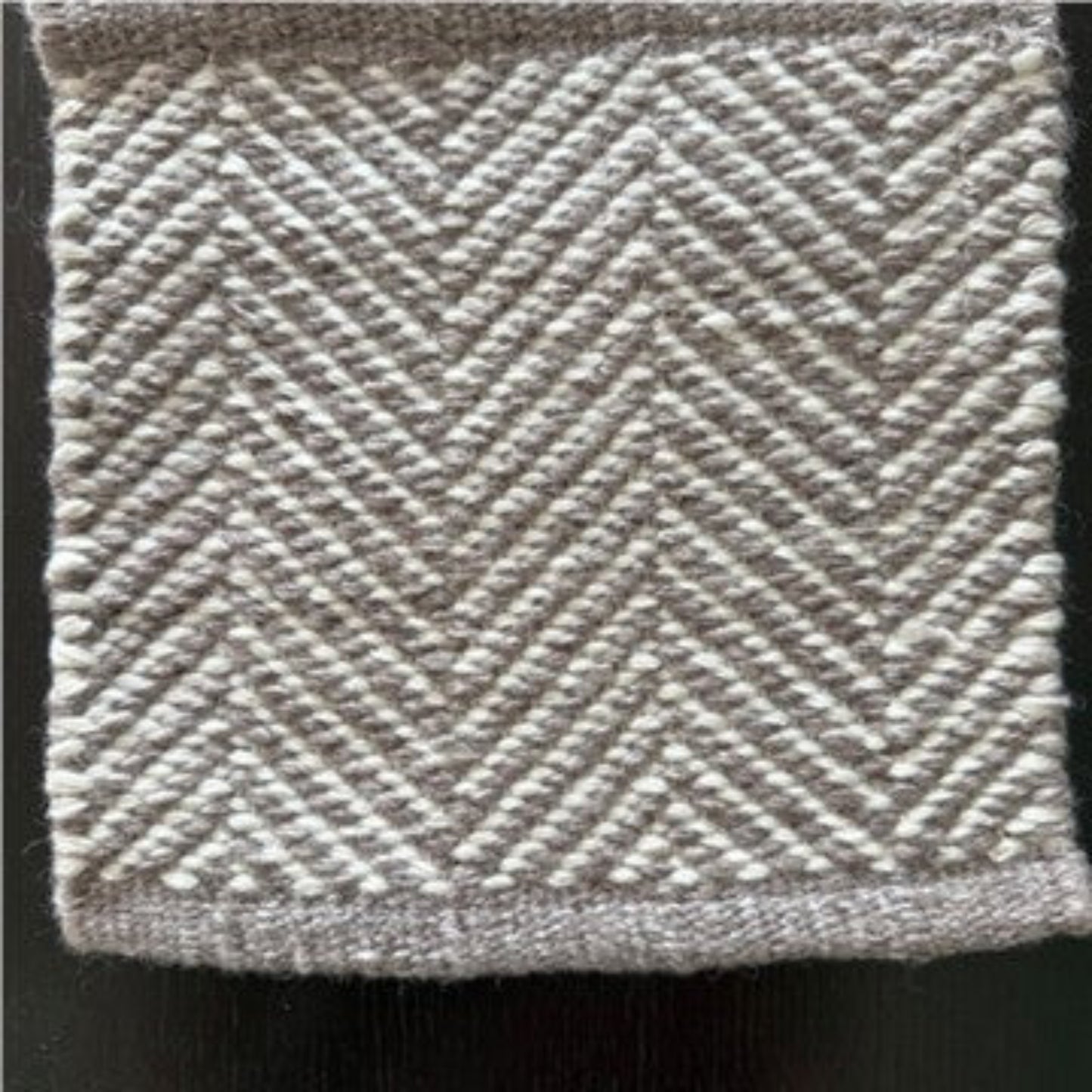 Close-up texture detail of the Davis herringbone weave pattern on a mould-resistant Zebra Home rug.