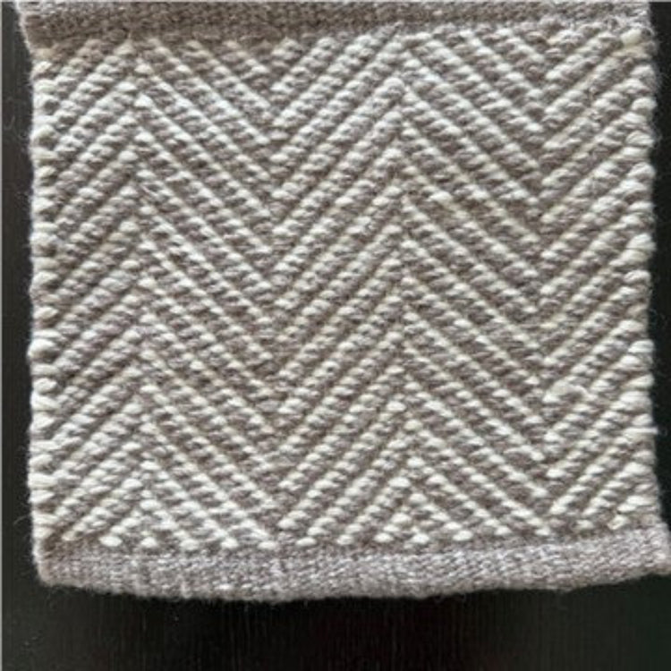 Close-up texture detail of the Davis herringbone weave pattern on a mould-resistant Zebra Home rug.