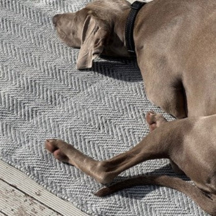 Zebra Home Henshall grey herringbone pet friendly outdoor runner mat styled on a timber patio deck.