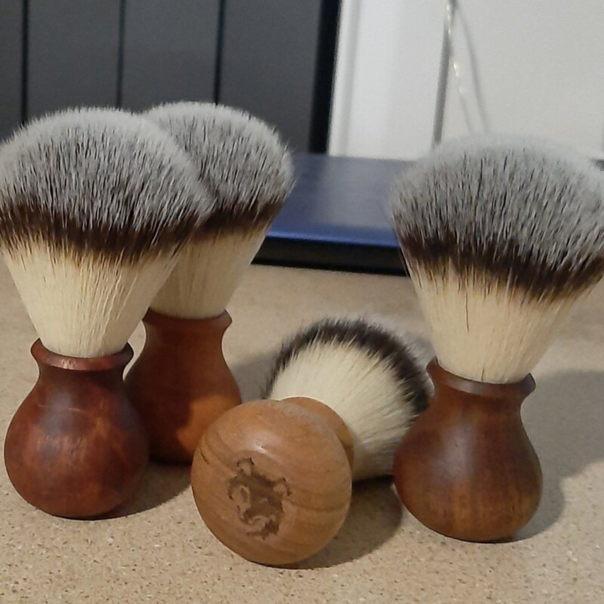 Artisan timber shaving brushes displayed showing recycled wood variation.